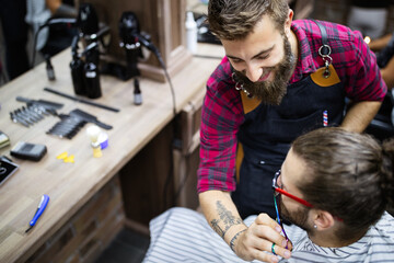 Client during beard and moustache grooming in barber shop