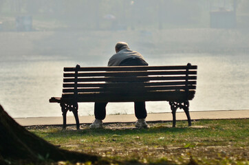 Naklejka na ściany i meble Belgrade, Serbia - November 01, 2011: A lonely older man is sitting alone on the bench