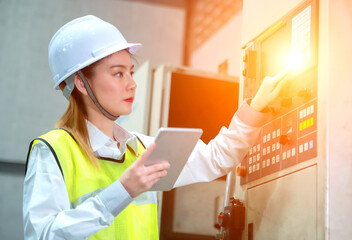Industry 4.0 concept.Female engineer inspecting in industrial factory.  Background blurred concept.