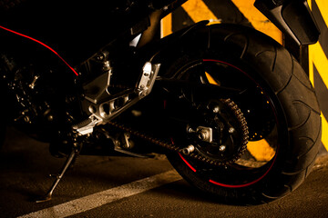 Black motorcycle on the background of underground parking.