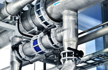 Close-up of a steel pipeline in an industrial city water treatment boiler room. Valves and pipe...