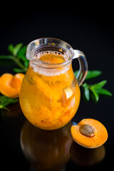 cold apricot compote in a glass decanter