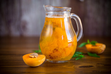 cold apricot compote in a glass decanter