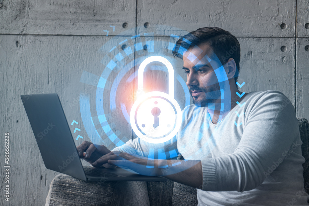 Poster a serious caucasian programmer in casual wears, using laptop to develop a new security system to pro