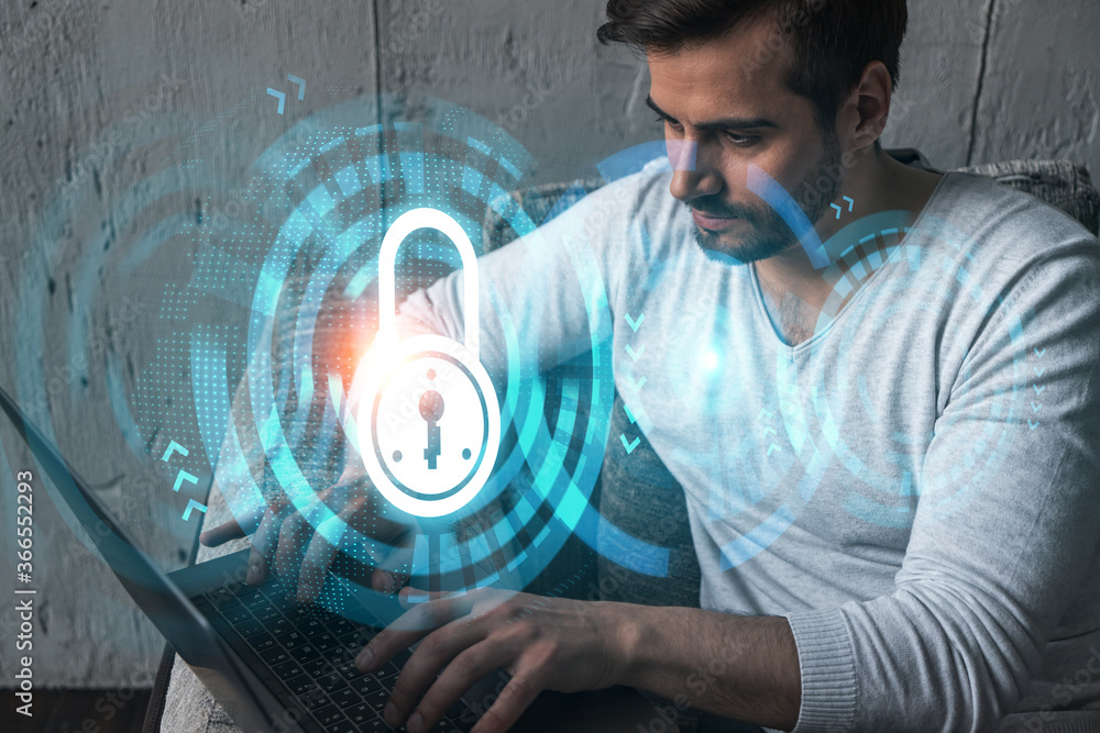 Poster a serious caucasian programmer in casual wears, using laptop to develop a new security system to pro