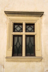 Fototapeta na wymiar Window with metal grate on a brick wall