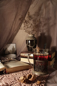 an open book left on the table in front of the table lamp