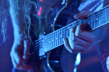 Obraz na płótnie Canvas Closeup of a guitar player on stage