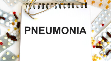 Medical Concept- Pneumonia word written on label tag with Stethoscope on wood background