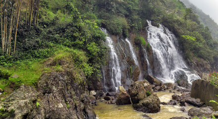 Waterfall cascade in jungle cliffs rock mountain river motion
