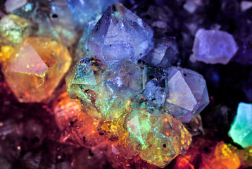 Iridescent natural transparent glossy and magic geometric Quartz crystal stucture through sun light.