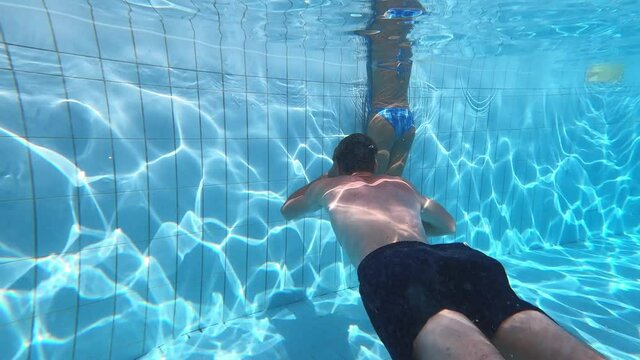  love games - young man swims underwater resurfaces and kissing his girfriend
