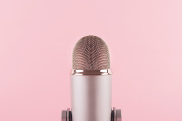 ASMR, karaoke, singing, recording concept. A professional microphone on pink background. Voice and...