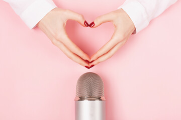 ASMR, karaoke, singing, recording concept. Woman hands in a heart shape and a professional...