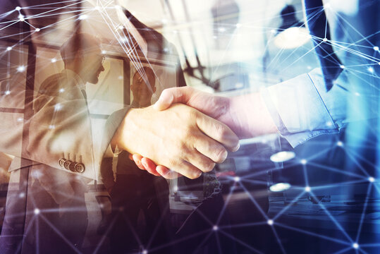 Handshaking business person in the office. concept of teamwork and partnership. double exposure with network effects