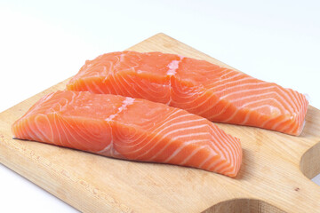 fresh salmon fillet on wooden board