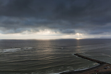Obraz premium rays of sun through clouds over the ocean