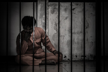 Asian man desperate at the iron prison,prisoner concept,thailand people,Hope to be free,Serious prisoners imprisoned in the prison
