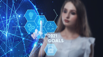 Business, Technology, Internet and network concept. Young businessman working on a virtual screen of the future and sees the inscription: 2021 goals