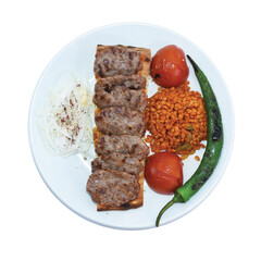 Turkish grilled meatballs on the plate with vegetables. Turkish traditional foods. 