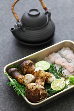 dobin mushi (Japanese cuisine) : steamed matsutake mushroom and pike conger with Japanese broth in an earthenware teapot and served.
