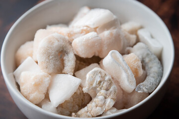 frozen seafood in white bowl