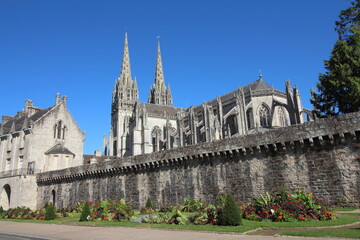 Fototapeta na wymiar Quimper town in Brittany France. Wall of old town and a beautiful garden near the Cathedral of Saint Corentin. Tourism in France.