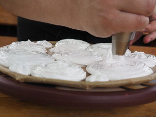 the cook makes meringue from cream.cooking cakes.