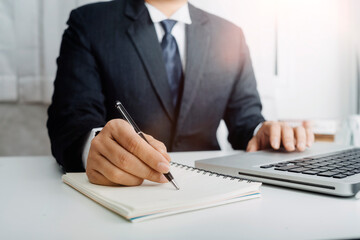 Businesswomen hands working with finances about cost and calculator and laptop with tablet, smartphone at office in morning light
