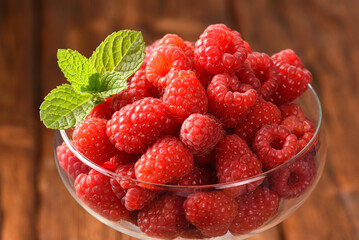 Raspberry and mint leaves in a glass.