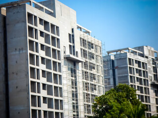 Naklejka premium Building under construction. New Housing Project. Upcoming Residential Projects Building. Under Constructions Projects in modern city. Tallest building in India under construction.