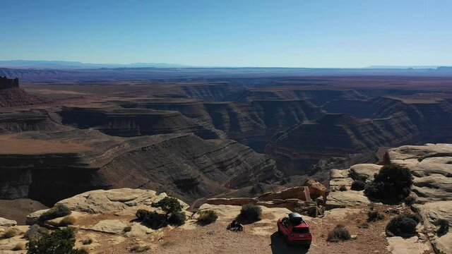 Aerial view of a car on a cliff of a Utah canyon