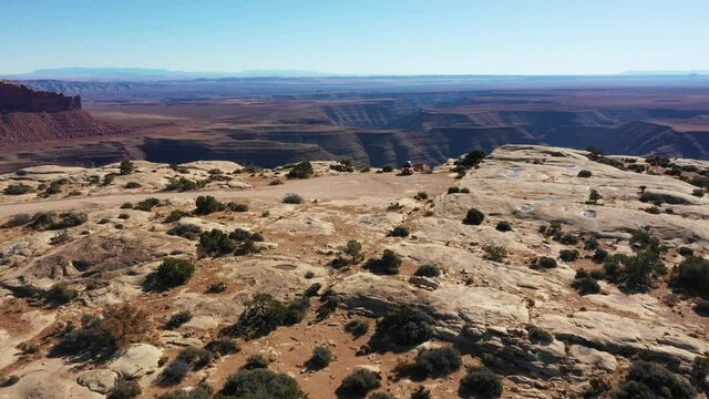 Aerial view of a car on a cliff of a Utah canyon