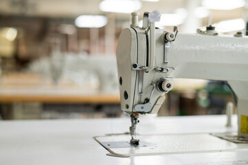 Interior of a workshop for sewing clothes and textiles. Without people. The workroom of seamstresses and dressmakers. Industrial scale.