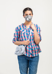 Portrait of a young girl with messenger bag and face covered with N95 mask during covid-19 pandemic in India