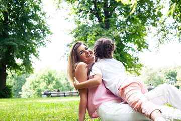 Fototapeta premium young pretty mother walking with little cute daughter outside in green park, lifestyle poeple concept