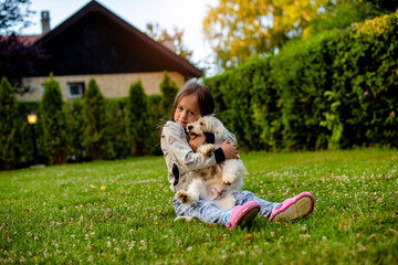 Girl is hugging a dog