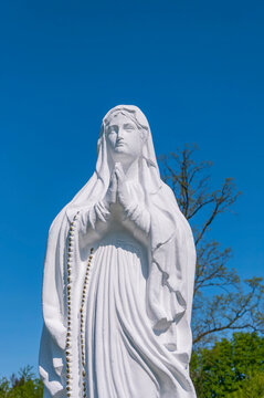 A sculpture of  Virgin Mary in the city parck. (faith concept)