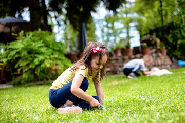 Little girl is playing on the grass