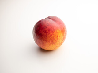 Peach, nectarine on a white background. Red and yellow.