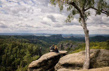 Two hikers on a rock offering a great view into Saxonias Switzerland / Zwei Wanderer auf einem...