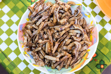 A cooked dish made from pork ears. Delicacy. The dish is on our table.