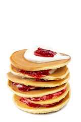 Stack of pancakes with sour cream and raspberry jam on white background