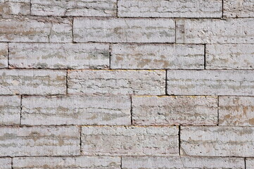 The wall is made of concrete blocks. Texture.