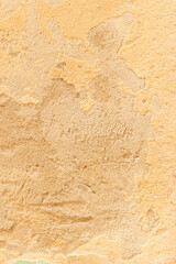 Old wall with peeling paint yellow