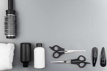 Professional hair dresser tools with copy space. Hair stylist equipment set on gray background....