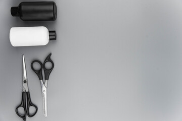 Professional hair dresser tools with copy space. Hair stylist equipment set on gray background....