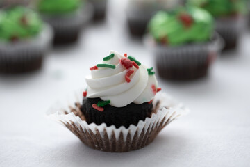 chocolate cupcake with icing and sprinkles ready to be eaten