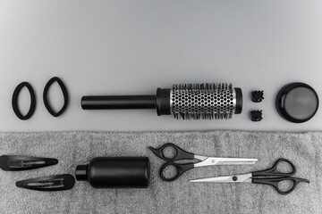 Professional hair dresser tools with copy space. Hair stylist equipment set on gray background....