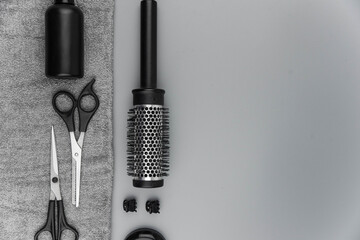 Professional hair dresser tools with copy space. Hair stylist equipment set on gray background....